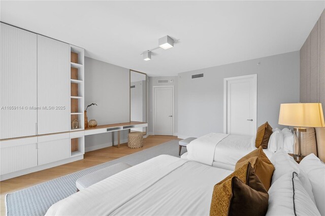 bathroom with walk in shower, vanity, hardwood / wood-style floors, and toilet