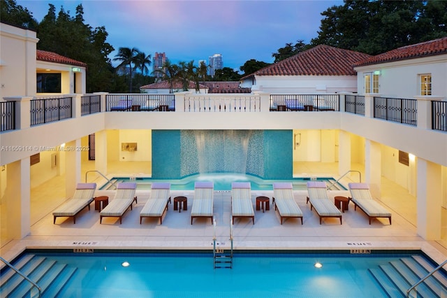 view of pool at dusk