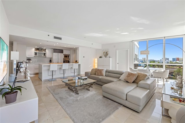 living room with light tile patterned floors and expansive windows