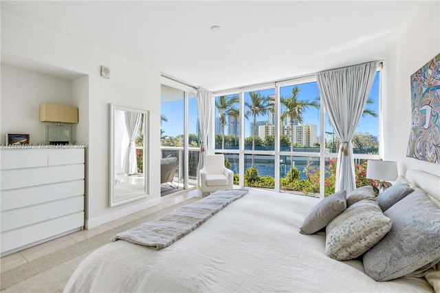 bedroom with light tile patterned floors and multiple windows