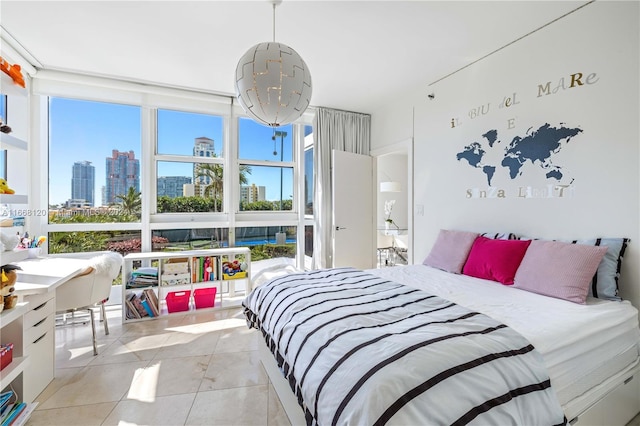 bedroom with light tile patterned flooring and expansive windows