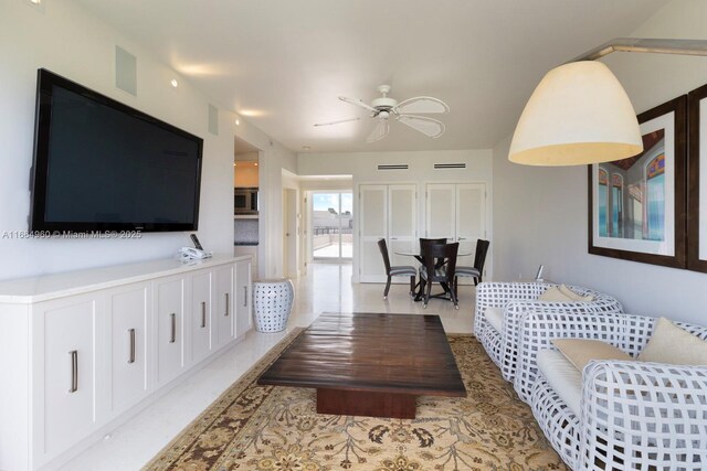 kitchen with white cabinets, stainless steel microwave, tasteful backsplash, and sink