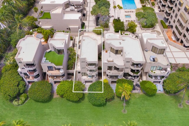 drone / aerial view featuring a water view and a view of the beach