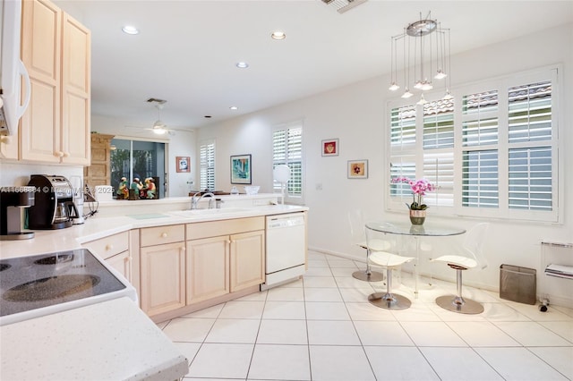 kitchen featuring sink, decorative light fixtures, light tile patterned floors, white dishwasher, and ceiling fan