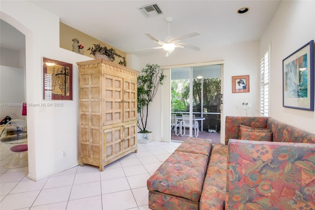 tiled living room with ceiling fan