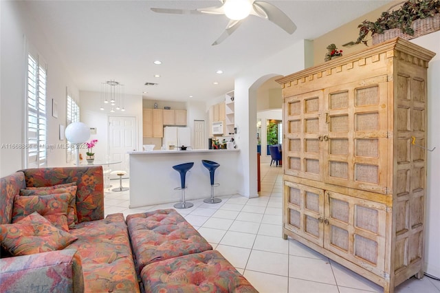 living room with light tile patterned floors and ceiling fan