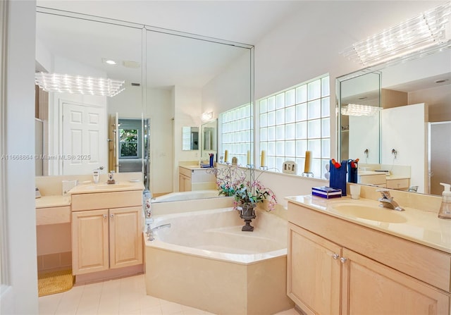 bathroom with vanity and shower with separate bathtub