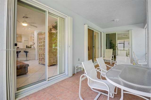 sunroom / solarium featuring ceiling fan