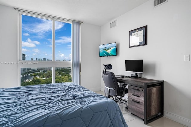 tiled bedroom with multiple windows