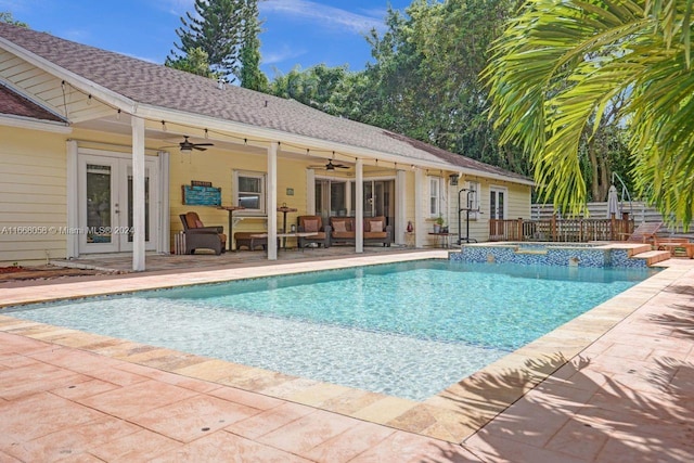 view of pool with ceiling fan, an in ground hot tub, a patio, and french doors