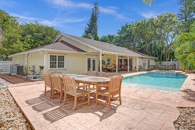 rear view of house featuring a lawn and a patio