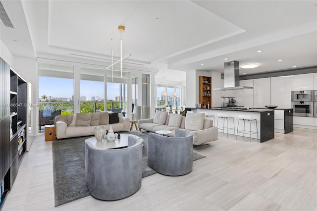 living room featuring a raised ceiling