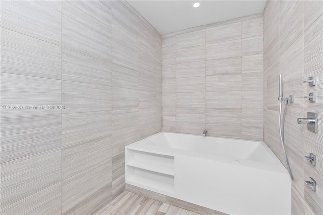 bathroom with tub / shower combination and tile walls