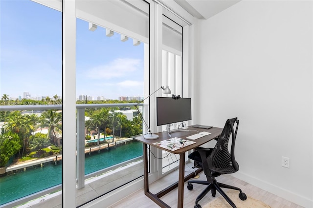 home office with light hardwood / wood-style flooring