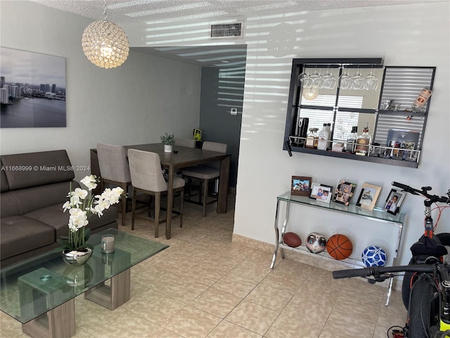 living room with a textured ceiling and a notable chandelier