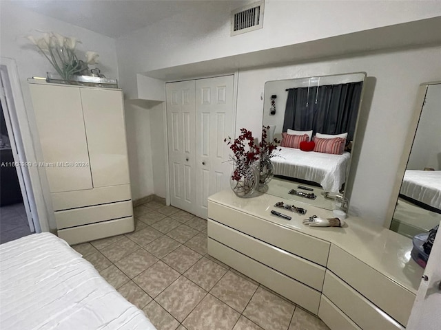 tiled bedroom featuring a closet