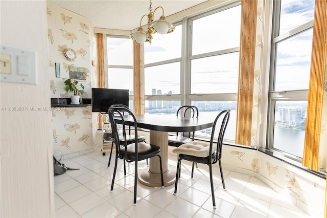 dining room with a notable chandelier, light tile patterned floors, and a wealth of natural light