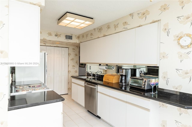 kitchen featuring white cabinets, dishwasher, a textured ceiling, and sink