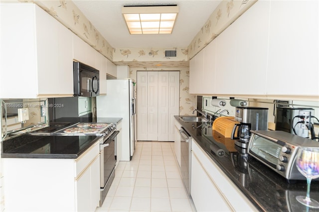 kitchen with white cabinetry, sink, and stainless steel appliances