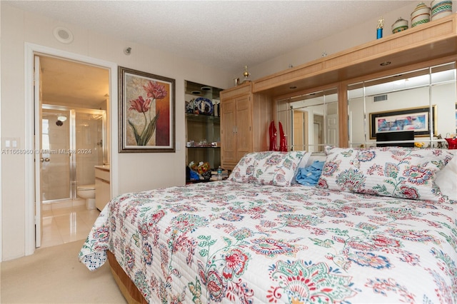 bedroom featuring a textured ceiling, connected bathroom, and light carpet