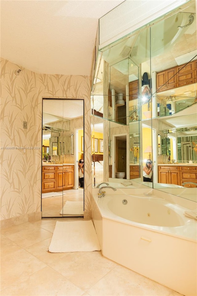 bathroom with vanity, a bathtub, and tile patterned flooring