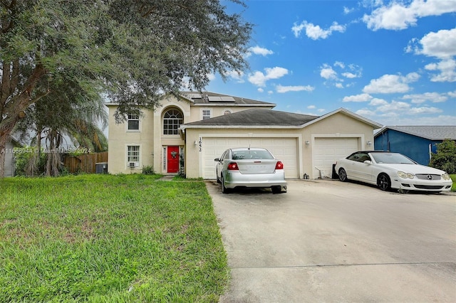 front of property with a garage and a front lawn