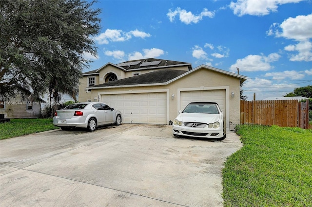 view of front of property with a front yard and a garage