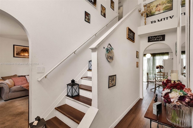 staircase with hardwood / wood-style floors