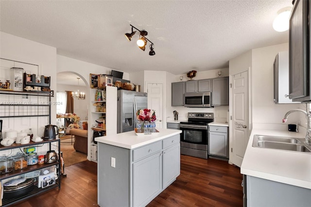 kitchen featuring gray cabinets, sink, stainless steel appliances, and dark hardwood / wood-style flooring