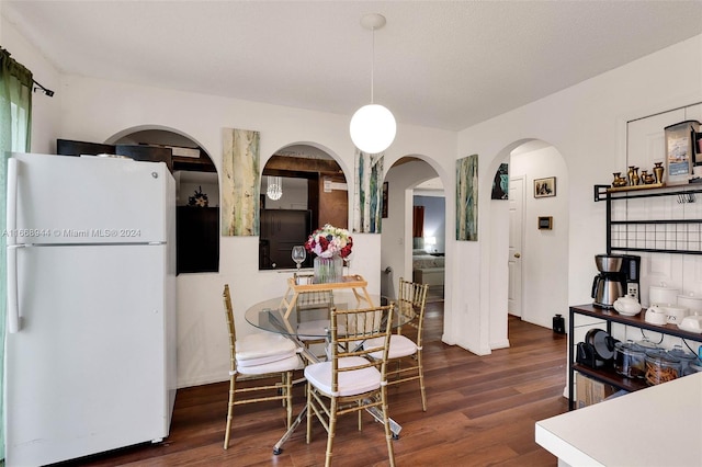 dining space with dark hardwood / wood-style flooring