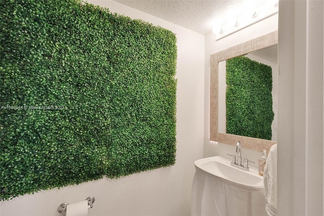 bathroom with a textured ceiling and sink