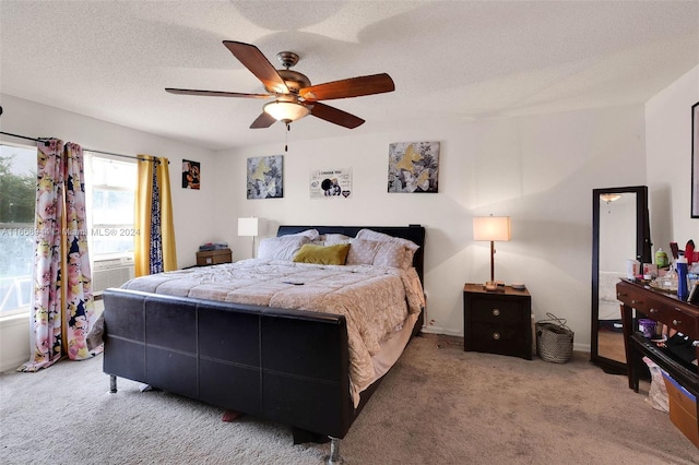 carpeted bedroom with a textured ceiling and ceiling fan