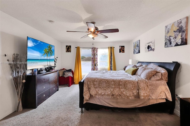 bedroom featuring a textured ceiling, carpet flooring, and ceiling fan