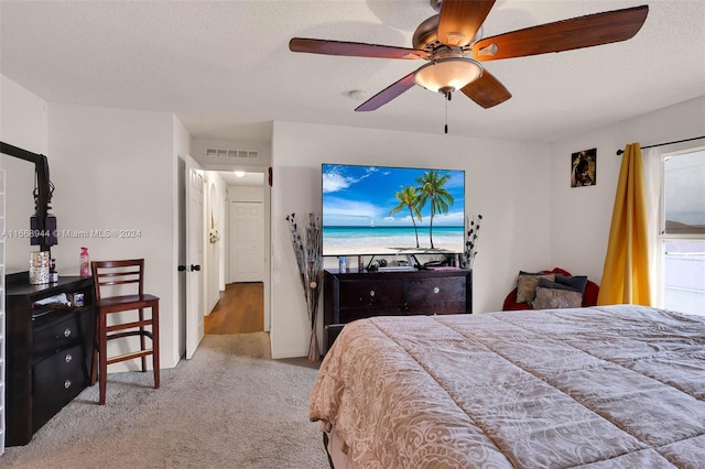 bedroom featuring ceiling fan, a textured ceiling, and carpet flooring