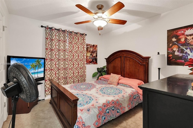 bedroom featuring a textured ceiling, light carpet, and ceiling fan