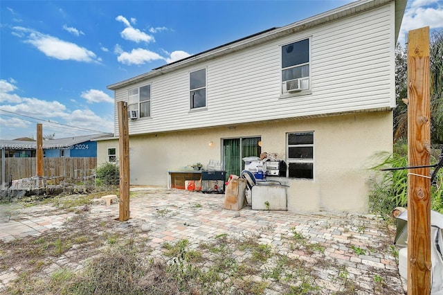 rear view of property featuring cooling unit and a patio area