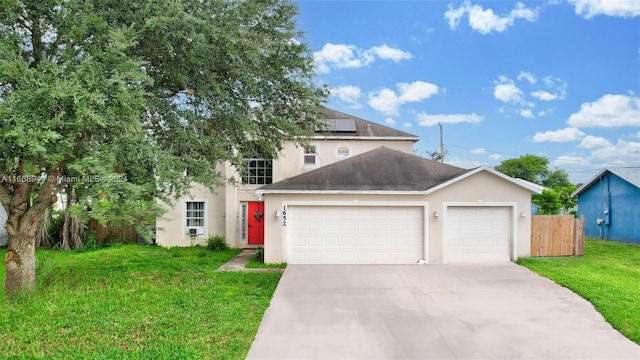 view of front of house featuring a front lawn and a garage