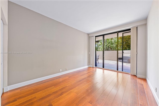 unfurnished room with hardwood / wood-style floors