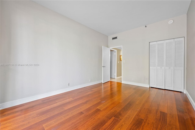 unfurnished bedroom with a closet and wood-type flooring