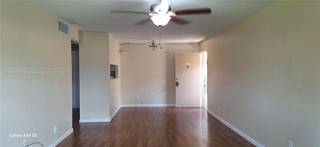 spare room featuring ceiling fan, dark hardwood / wood-style floors, and a textured ceiling