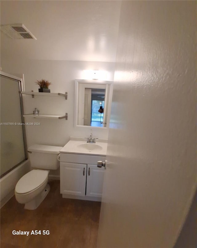 full bathroom featuring tile patterned floors, toilet, shower / bath combination with glass door, and vanity