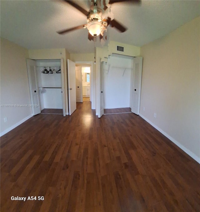 unfurnished bedroom featuring dark hardwood / wood-style floors and ceiling fan