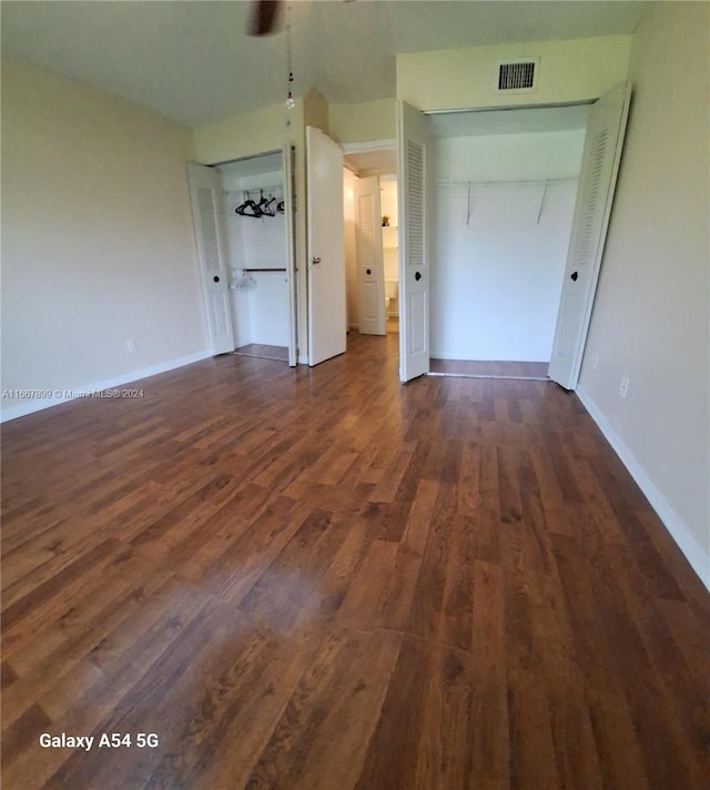 unfurnished bedroom featuring dark wood-type flooring and a closet