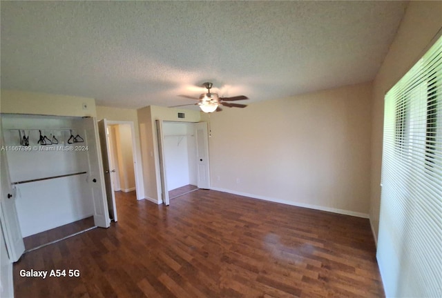 interior space featuring dark hardwood / wood-style floors, a textured ceiling, and ceiling fan