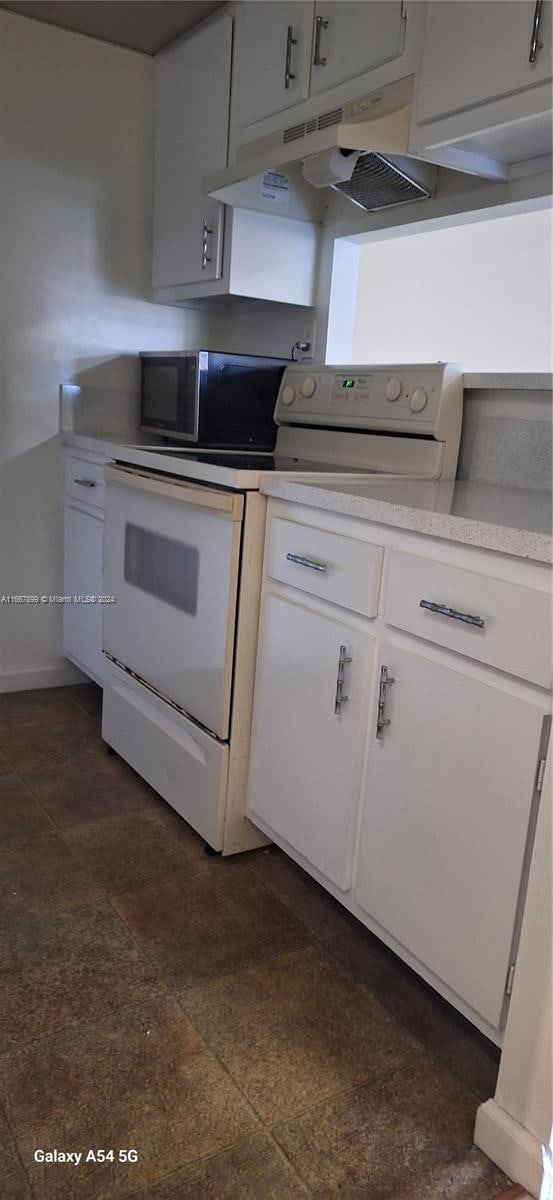 kitchen with white cabinets and white range with electric cooktop