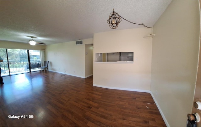 spare room featuring a textured ceiling, ceiling fan, and dark hardwood / wood-style flooring