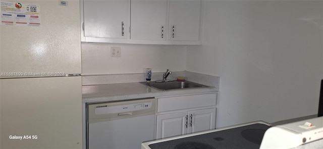 kitchen featuring white cabinetry, white appliances, and sink