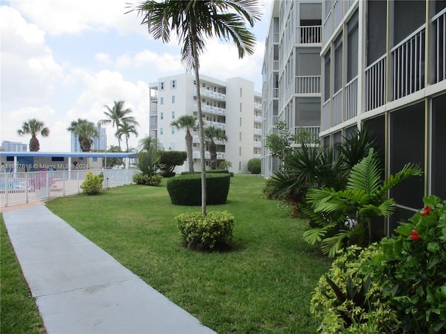 view of home's community featuring a lawn