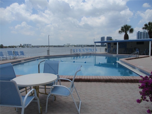 view of pool with central AC and a patio area