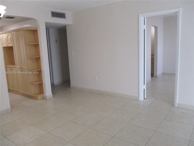 empty room with light tile patterned floors